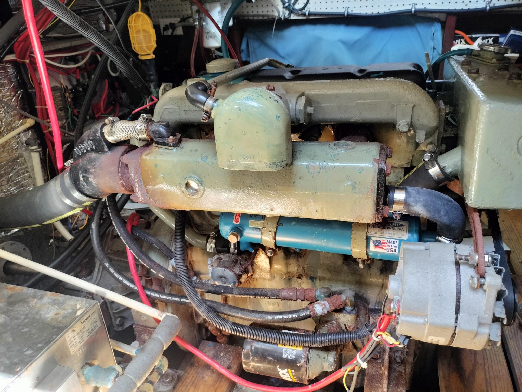 Slide: The Image of Engine compartment of a 1991 Trawler 38, showcasing mechanical components and wiring. - 39