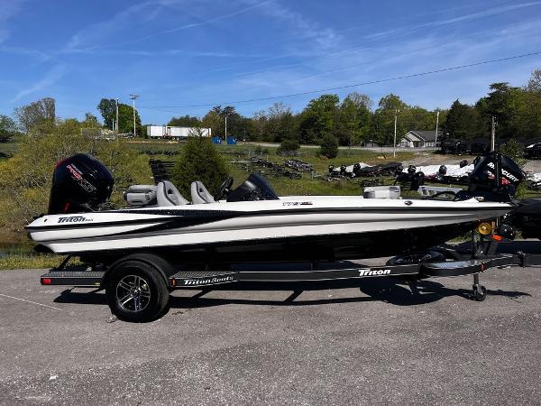 Slide: The Image of 2023 Triton 179 TrX fishing boat on trailer, parked outdoors. - 1