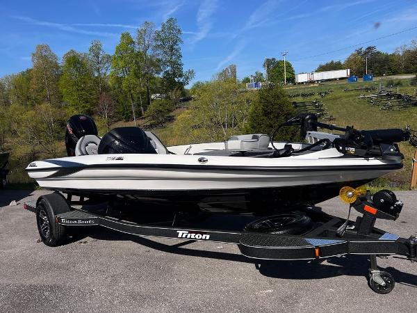 Slide: The Image of 2023 Triton 179 TrX fishing boat on trailer, parked outdoors. - 5
