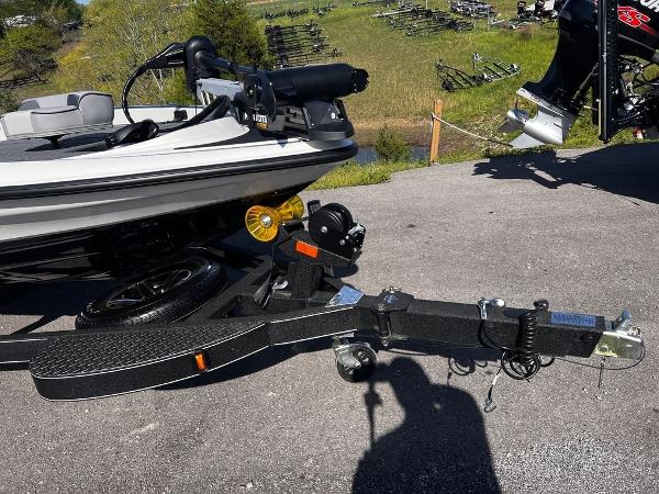 Slide: The Image of 2023 Triton 179 TrX boat on a trailer, parked outdoors. - 7