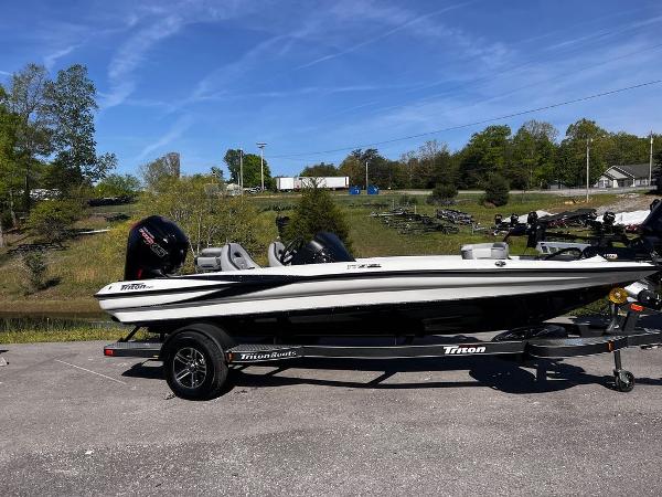 Slide: The Image of 2023 Triton 179 TrX boat on trailer in outdoor setting. - 9