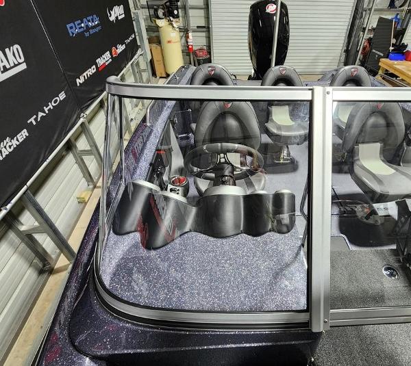 Slide: The Image of 2024 Triton 186 Allure boat interior with steering wheel and seating. - 1