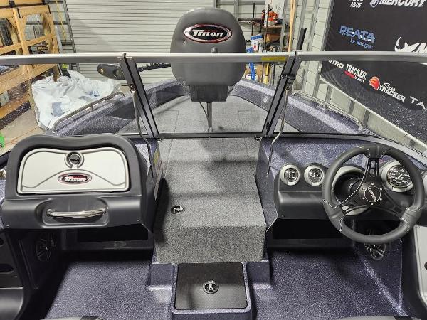 Slide: The Image of 2024 Triton 186 Allure boat interior with steering wheel and dashboard. - 2