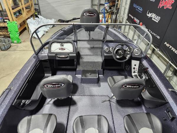 Slide: The Image of 2024 Triton 186 Allure fishing boat interior with steering console and seating. - 5