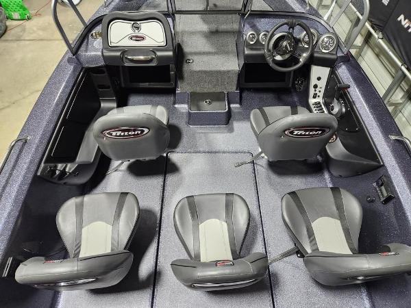 Slide: The Image of 2024 Triton 186 Allure boat interior with four seats and steering console. - 6