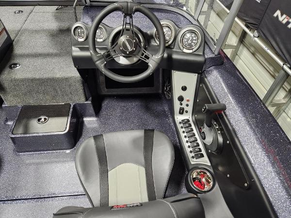 Slide: The Image of 2024 Triton 186 Allure boat cockpit with steering wheel and control panel. - 7