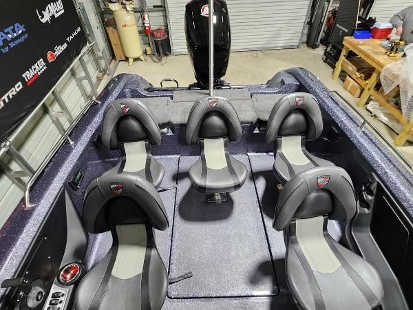 Slide: The Image of 2024 Triton 186 Allure boat interior with six seats in a garage. - 8