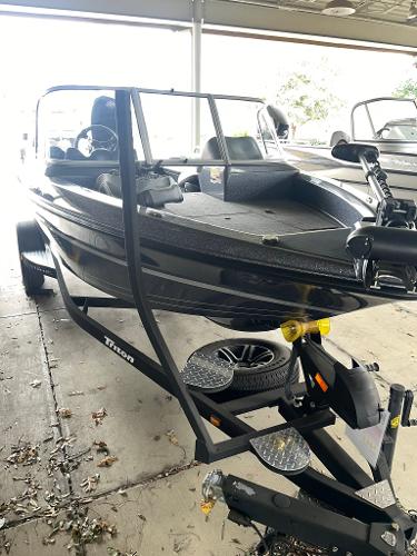 Slide: The Image of 2023 Triton 186 Fishunter boat on trailer in covered storage. - 0