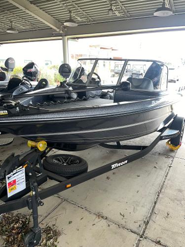 Slide: The Image of 2023 Triton 186 Fishunter boat on trailer under shelter. - 1