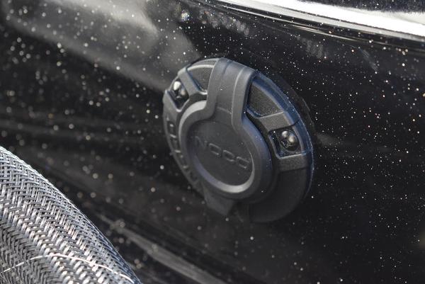 Slide: The Image of Close-up of a 2024 Triton 18 TrX boat's black exterior with a mounted accessory. - 10