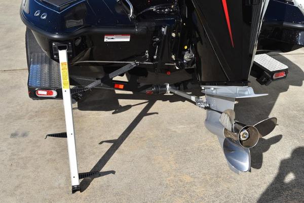 Slide: The Image of 2024 Triton 18 TrX boat motor and propeller on concrete surface. - 11