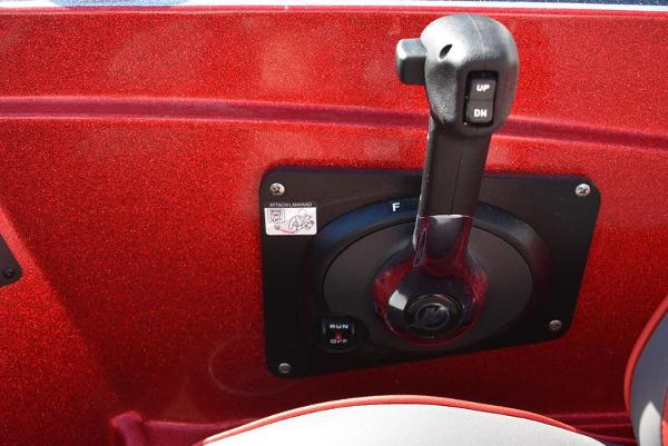 Slide: The Image of 2024 Triton 18 TrX boat throttle control lever in red interior. - 11