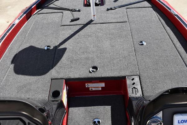 Slide: The Image of 2024 Triton 18 TrX boat deck with gray carpet and storage compartments. - 13