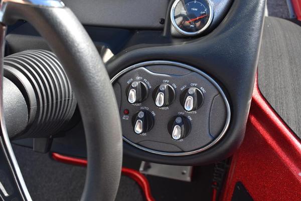 Slide: The Image of Control panel of 2024 Triton 18 TrX boat with switches and gauge. - 14