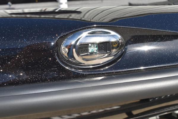 Slide: The Image of 2024 Triton 18 TrX boat detail with metallic black finish and chrome accent. - 18