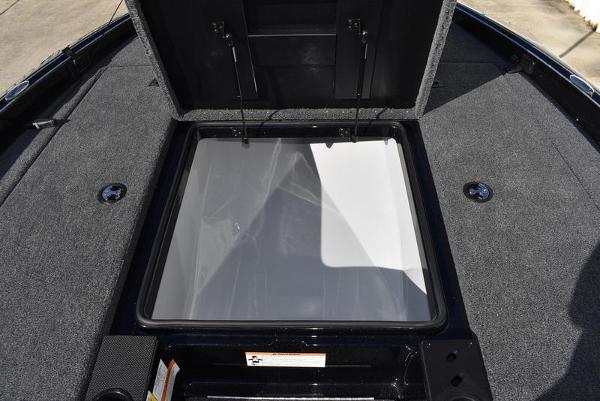 Slide: The Image of 2024 Triton 18 TrX boat storage compartment with open lid. - 21