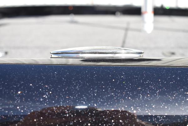 Slide: The Image of 2024 Triton 18 TrX boat with metallic finish and deck detail. - 22