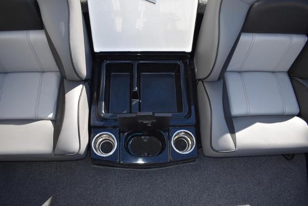 Slide: The Image of 2024 Triton 18 TrX boat interior with storage compartments and cup holders. - 23