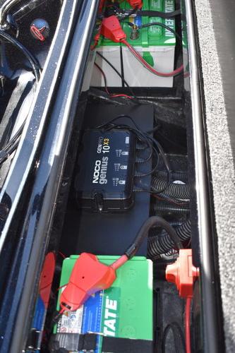 Slide: The Image of 2024 Triton 18 TrX boat battery compartment with NOCO Genius charger. - 24