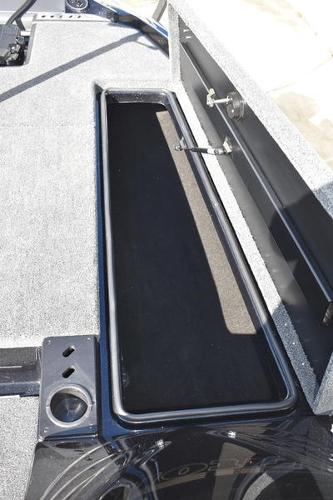 Slide: The Image of 2024 Triton 18 TrX boat storage compartment with open lid. - 25