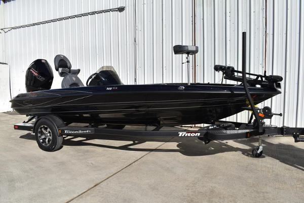 Slide: The Image of 2024 Triton 18 TrX bass boat on trailer, black exterior. - 26