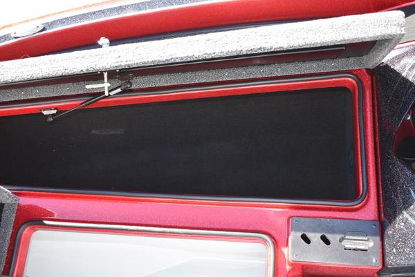 Slide: The Image of 2024 Triton 18 TrX boat storage compartment with open lid. - 26