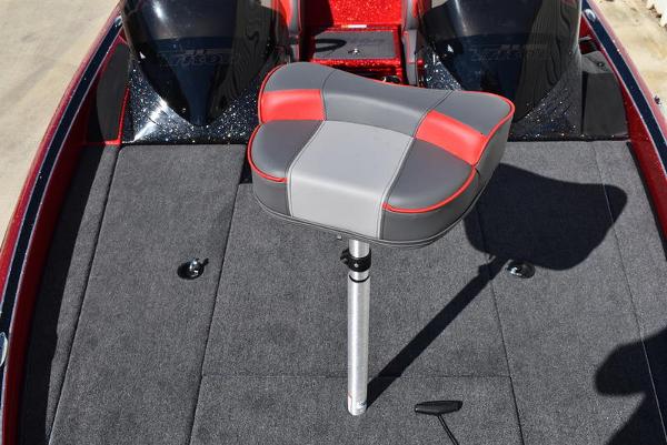 Slide: The Image of 2024 Triton 18 TrX boat with a cushioned seat on the deck. - 31
