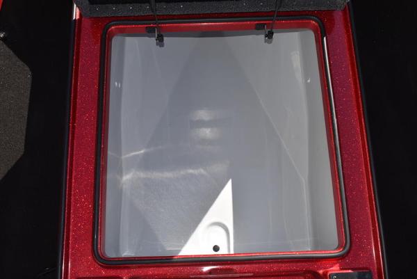 Slide: The Image of 2024 Triton 18 TrX boat storage compartment with red trim. - 34