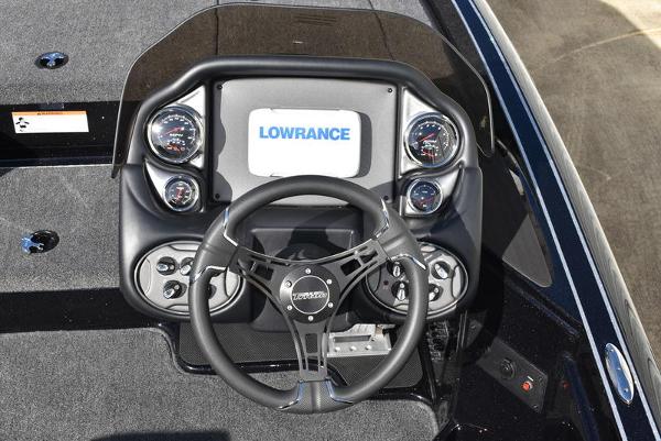 Slide: The Image of 2024 Triton 18 TrX boat dashboard with Lowrance display and steering wheel. - 35