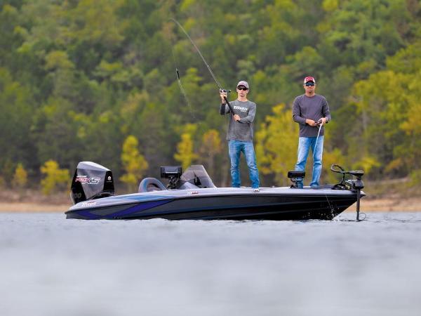 Slide: The Image of 2024 Triton 18 TrX boat with two people fishing on a lake. - 36