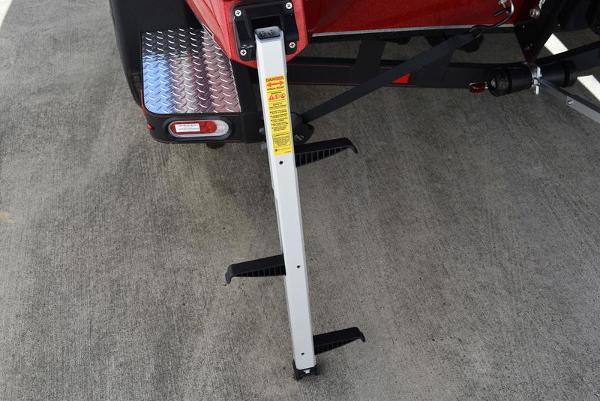 Slide: The Image of 2024 Triton 18 TrX boat trailer with foldable step ladder. - 36