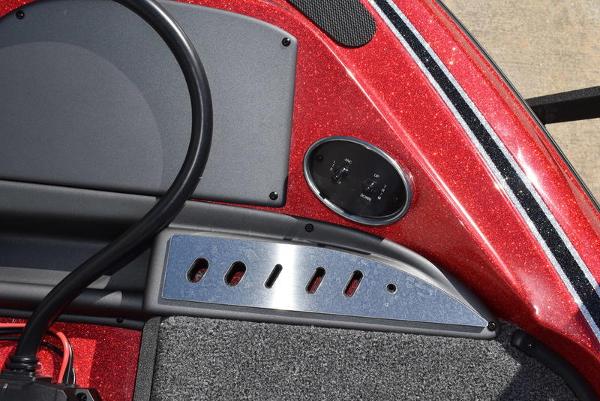 Slide: The Image of 2024 Triton 18 TrX boat dashboard with red metallic finish and control panel. - 37