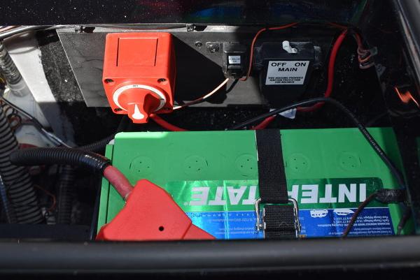 Slide: The Image of 2024 Triton 18 TrX boat battery compartment with Interstate battery and main power switch. - 4