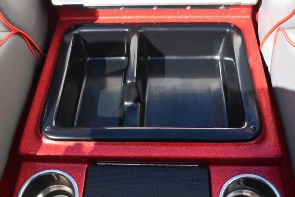 Slide: The Image of 2024 Triton 18 TrX boat storage compartment with dual cup holders. - 47