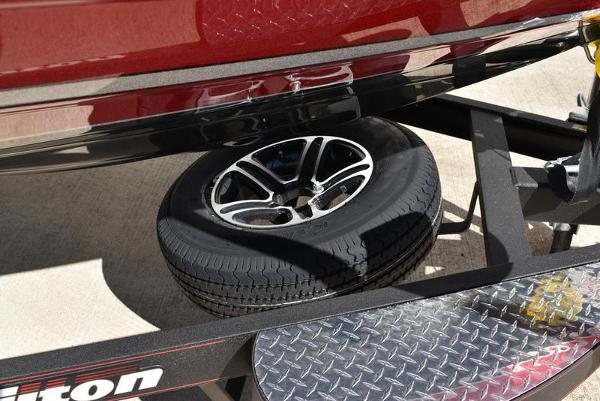 Slide: The Image of 2024 Triton 18 TrX boat trailer with spare tire and diamond plate step. - 49