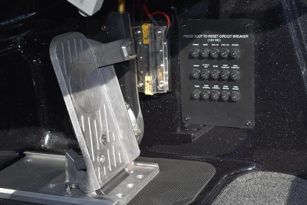 Slide: The Image of 2024 Triton 18 TrX boat control panel and foot pedal. - 5