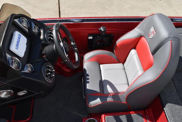 Slide: The Image of 2024 Triton 18 TrX boat cockpit with red and gray captain's seat. - 5