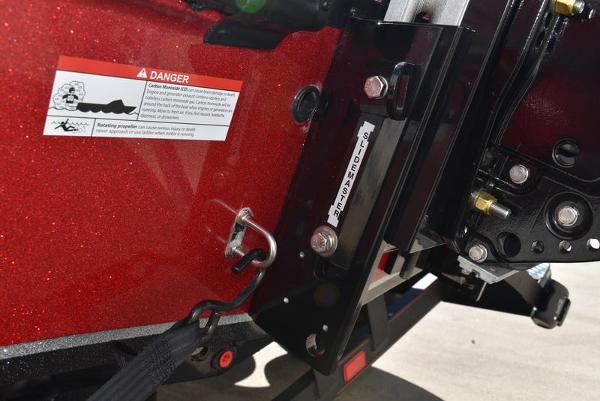 Slide: The Image of Close-up of 2024 Triton 18 TrX boat's red exterior with safety warning label. - 7