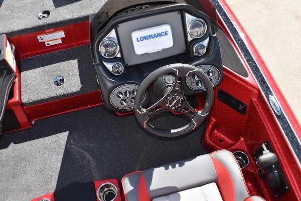 Slide: The Image of 2024 Triton 18 TrX boat cockpit with Lowrance electronics and steering wheel. - 8