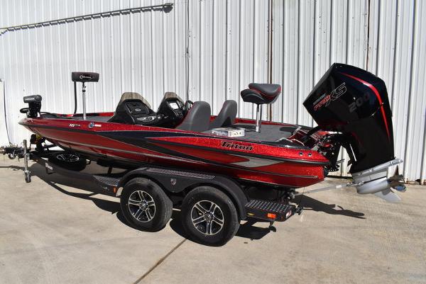Slide: The Image of 2024 Triton 18 TrX bass boat on trailer, red and black. - 9