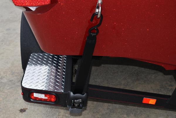 Slide: The Image of 2024 Triton 206 Allure boat trailer with diamond plate step and red finish. - 38