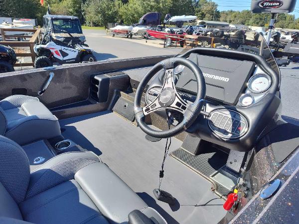 Slide: The Image of 2024 Triton 21 TrX boat interior with steering wheel and dashboard. - 5