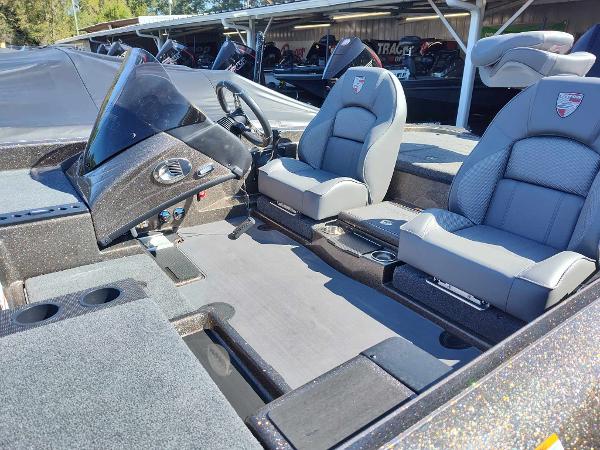 Slide: The Image of 2024 Triton 21 TrX boat interior with dual seats and steering console. - 8