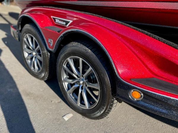 Slide: The Image of Close-up of 2023 Triton 21 TrX Patriot boat trailer wheels. - 12