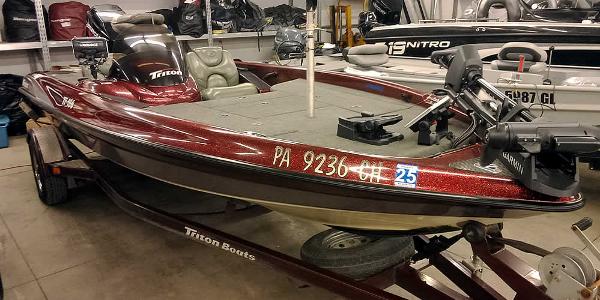 Slide: The Image of 2001 Triton TR186 SC bass boat on trailer in garage. - 1