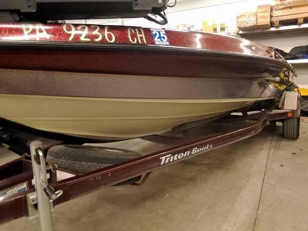 Slide: The Image of 2001 Triton TR186 SC boat on trailer in garage setting. - 5
