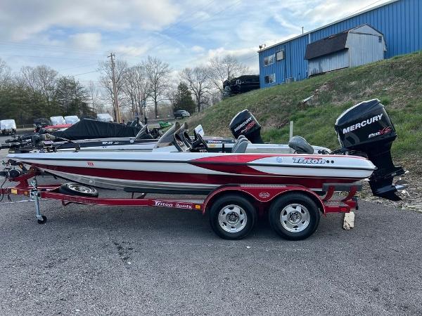 Slide: The Image of 1999 Triton TR20 boat on trailer with Mercury outboard motor, parked outdoors. - 5