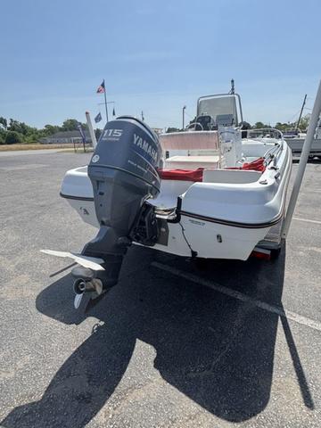 Slide: The Image of 2002 Triumph 190 Bay boat with Yamaha 115 outboard motor in a parking lot. - 3