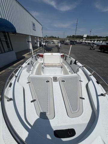 Slide: The Image of 2002 Triumph 190 Bay boat, white deck, parked outdoors under clear sky. - 4