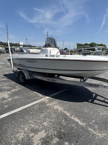 Slide: The Image of 2002 Triumph 190 Bay boat on trailer in parking lot under clear sky. - 5